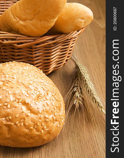 Basket with bread and wheat on the table