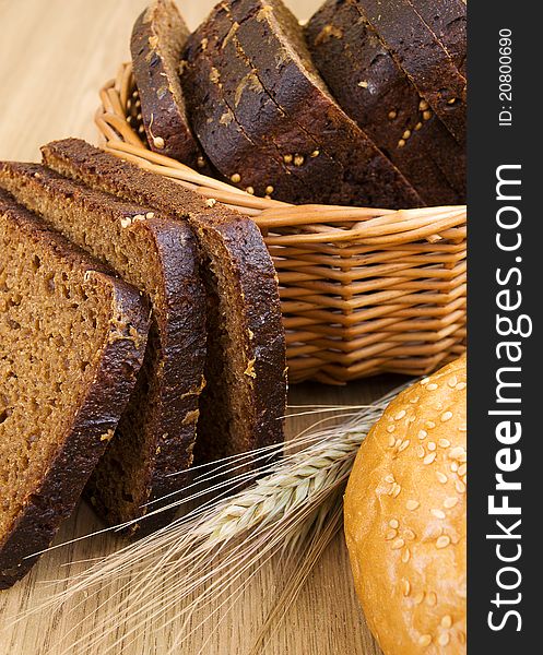 Basket with bread and wheat on the table