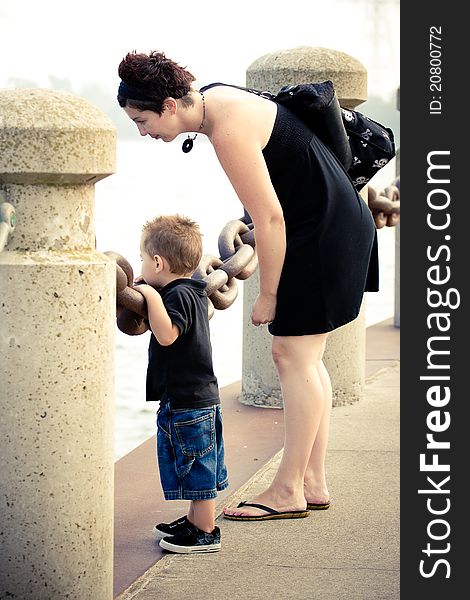 A mother and son spending time together looking at water.