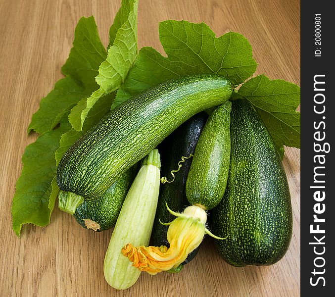 Fresh marrows with green leaves on the table