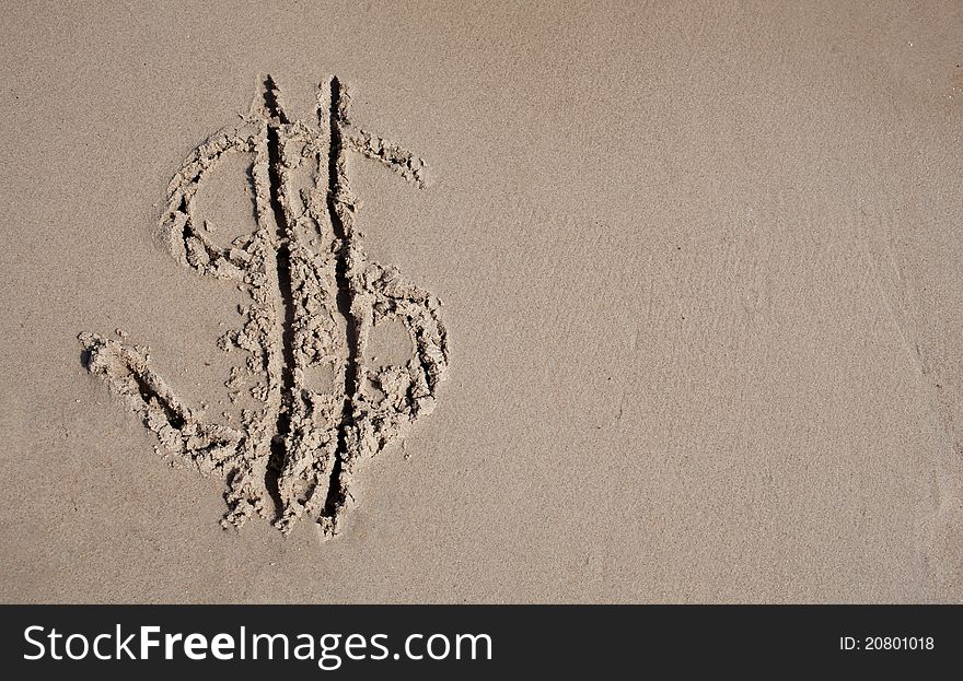 Dollar sign on sand beach
