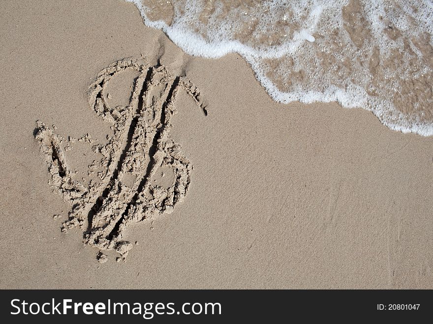 Dollar sign on sand beach