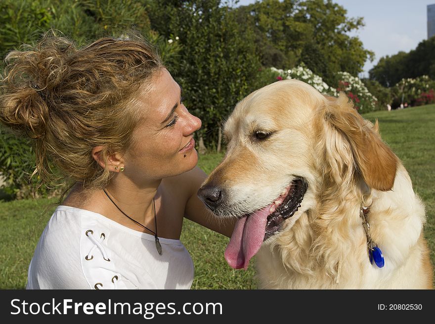 Girl in a park hugging her dog. Girl in a park hugging her dog