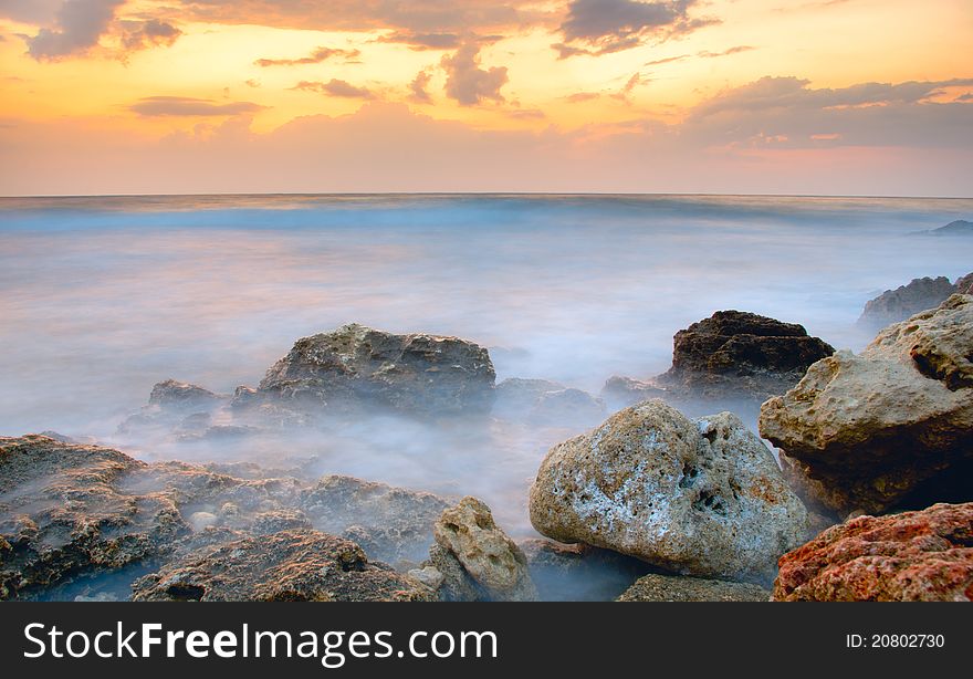 Frozen sea on the background of golden clouds