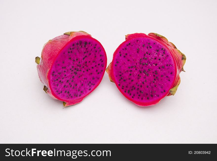 A dragon fruit divided in two on isolated background