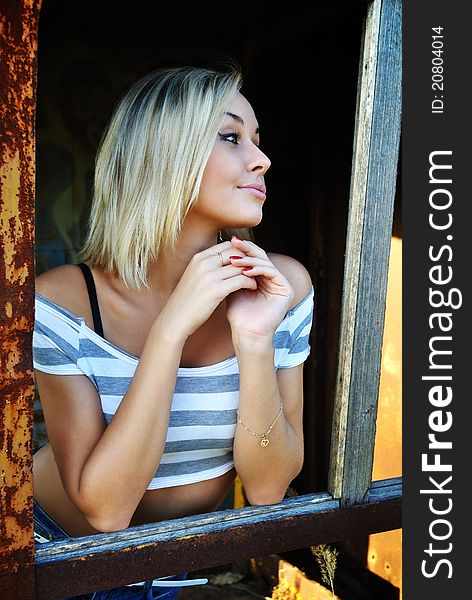 Beautiful girl, standing at a fence