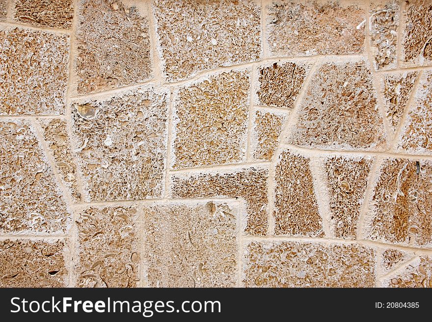 Wall of limestone formed by different geometric forms