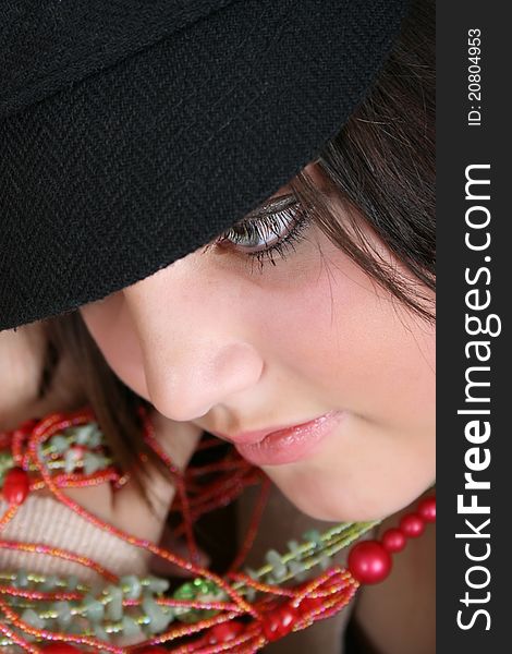 Close-up of a beautiful brunette teen wearing a hat. Close-up of a beautiful brunette teen wearing a hat