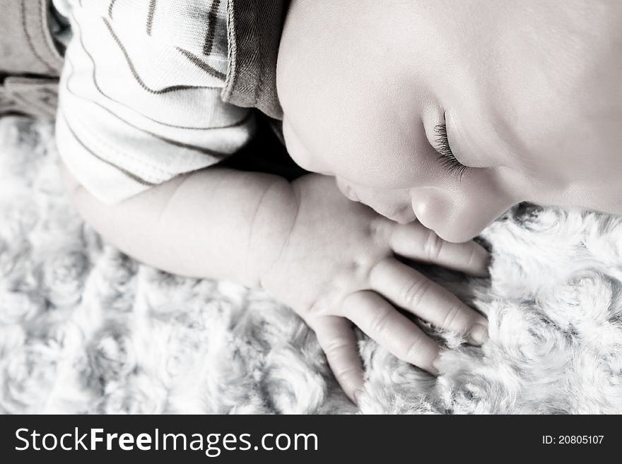 Beautiful newborn baby boy sleeping on a soft blanket. Beautiful newborn baby boy sleeping on a soft blanket