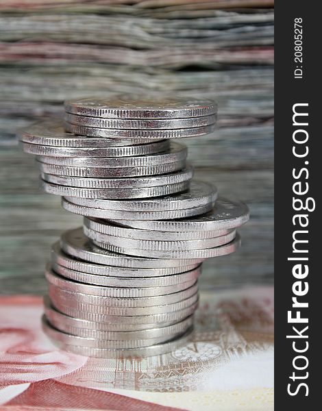 Stack of Canadian dollar bills with coins in front. Stack of Canadian dollar bills with coins in front