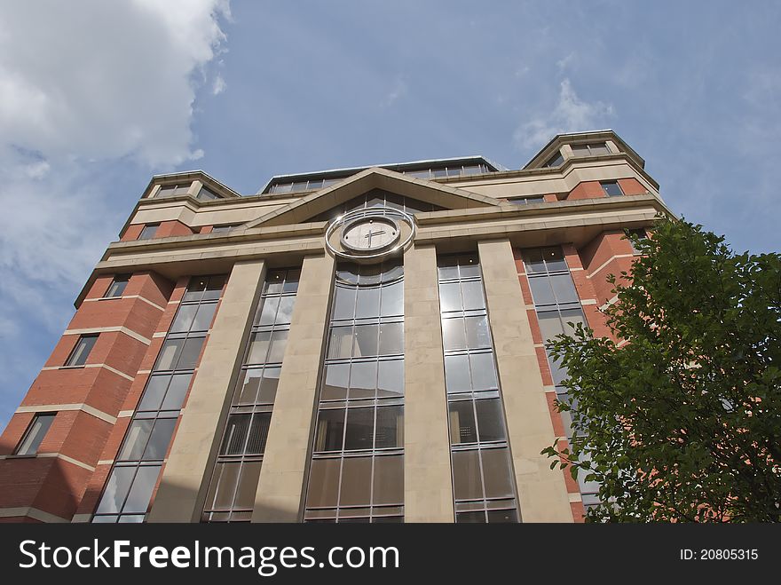 A Red Brick and Glass Office Block with Modern Clock