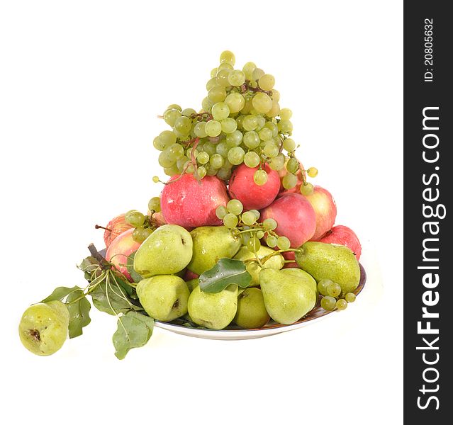 Apples, pears, grapes lie on a plate. Apples, pears, grapes lie on a plate