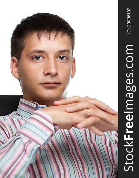 Portrait of a young thinking businessman on white background sitting in a chair