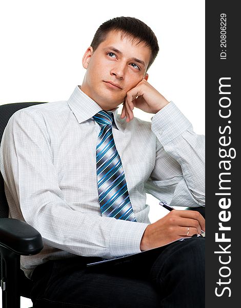 Portrait of adreaming young businessman, isolated on a white background sitting on a chair. Portrait of adreaming young businessman, isolated on a white background sitting on a chair