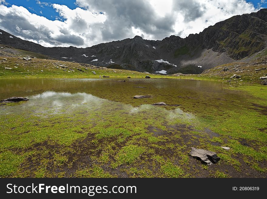 Small lake in high mountain during summer. Small lake in high mountain during summer