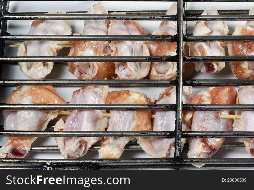 Grilled chicken wings getting ready on charcoal fire