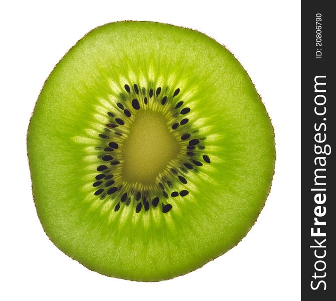 Backlit slice of fresh green kiwi fruit