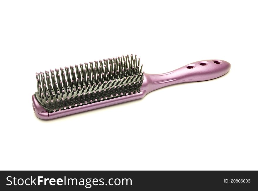 An image of a red hairbrush on white background
