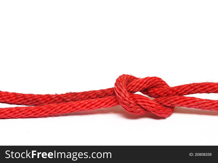 Red rope with a knot isolated on white