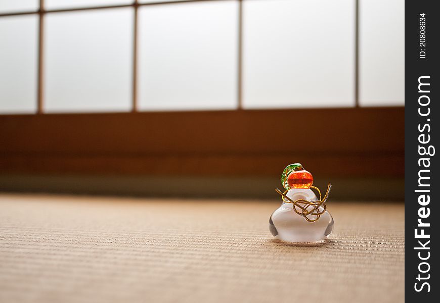 Traditional Japanese new years decoration in crystal, on a tatami mat floor. Traditional Japanese new years decoration in crystal, on a tatami mat floor