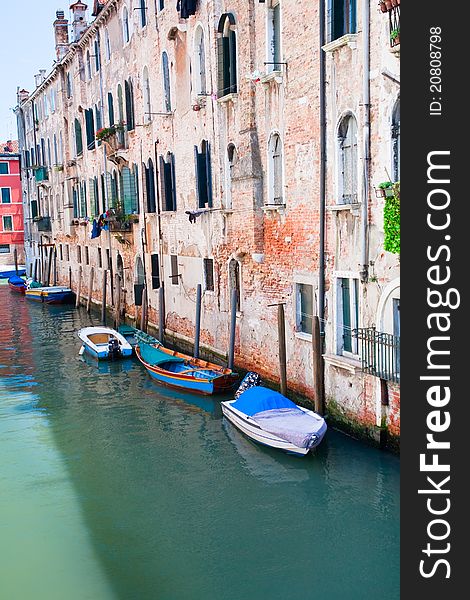 Parked boats on canal in Venice, Italy