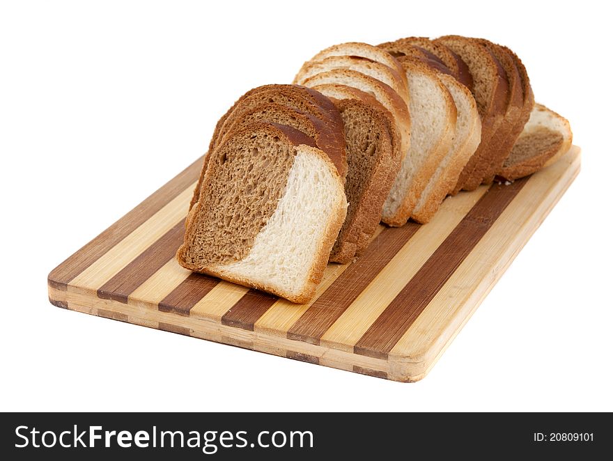 Sliced bread on a board on a white background