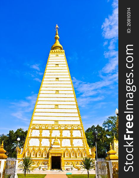 Thai white pagoda in the front view with blue sky and white cloud. Thai white pagoda in the front view with blue sky and white cloud