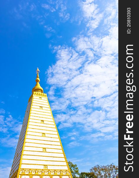 Thai white pagoda in the obligue view with blue sky and white cloud. Thai white pagoda in the obligue view with blue sky and white cloud