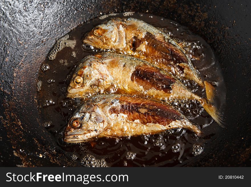 Fresh fish frying in hot oil. Fresh fish frying in hot oil