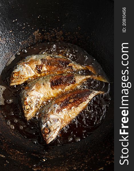 Food cooking, fresh fish in hot oil. Food cooking, fresh fish in hot oil