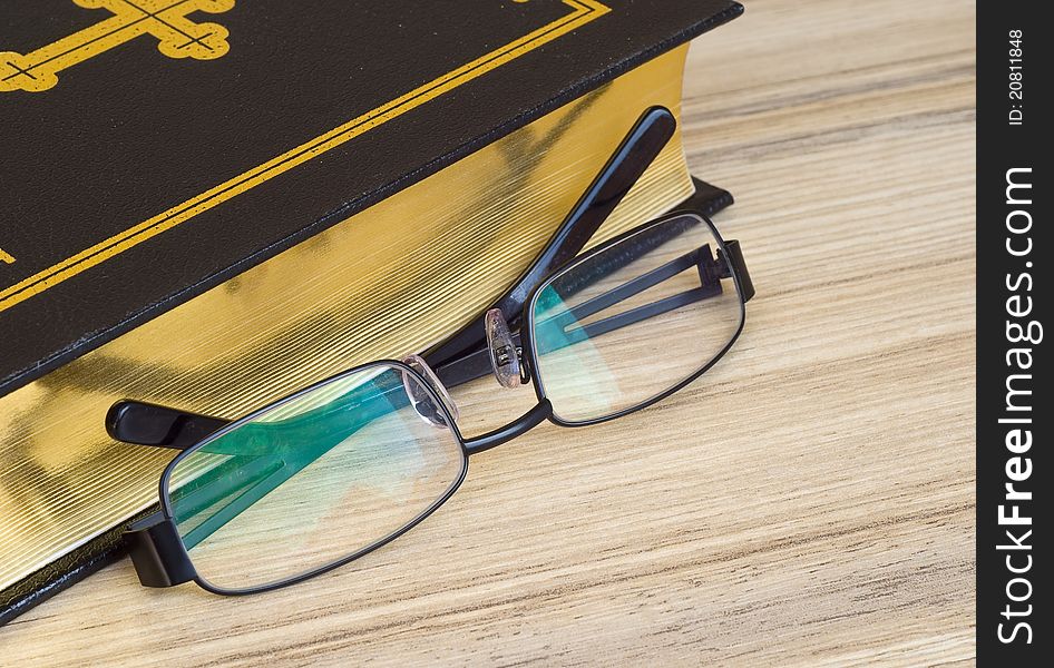 Glasses against the religious book