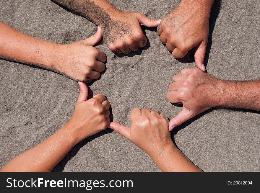 Image of  hands on sand - circle form