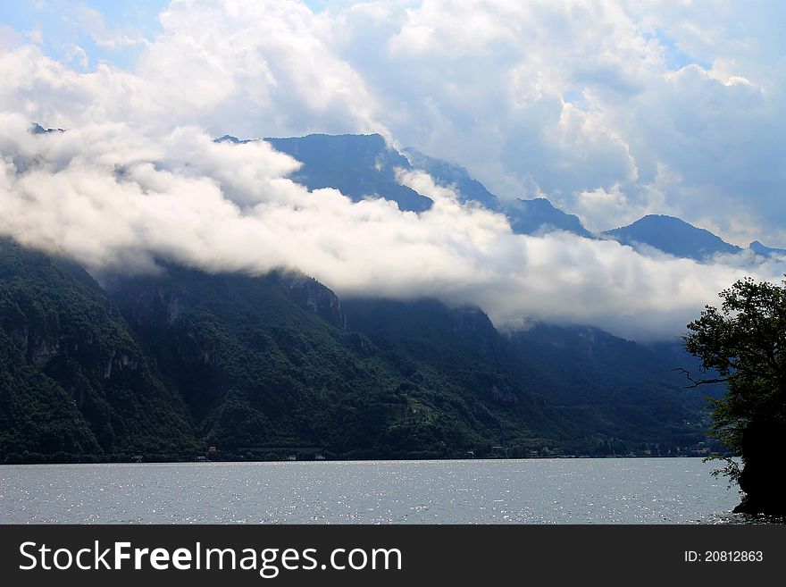 Cock clouds laying down over mountain at Como lake, Italy. Cock clouds laying down over mountain at Como lake, Italy