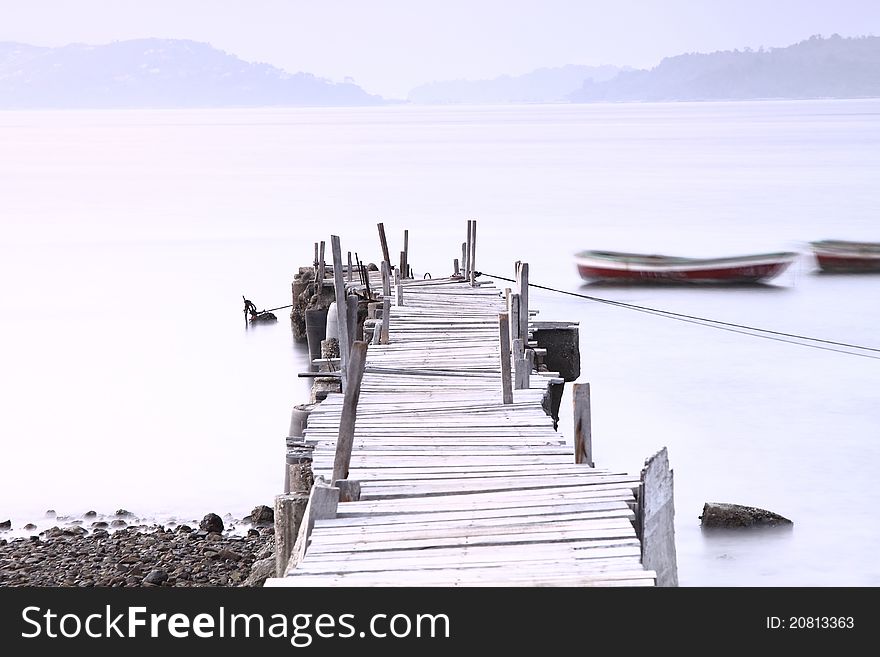 Wooden Pier At Dusk Under Long Exposure