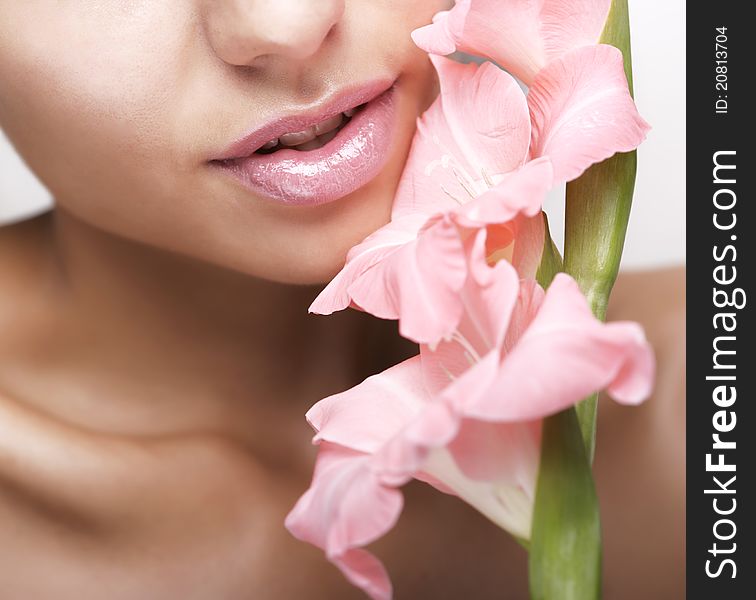 Beautiful Women With Flower And Cosmetic Cream