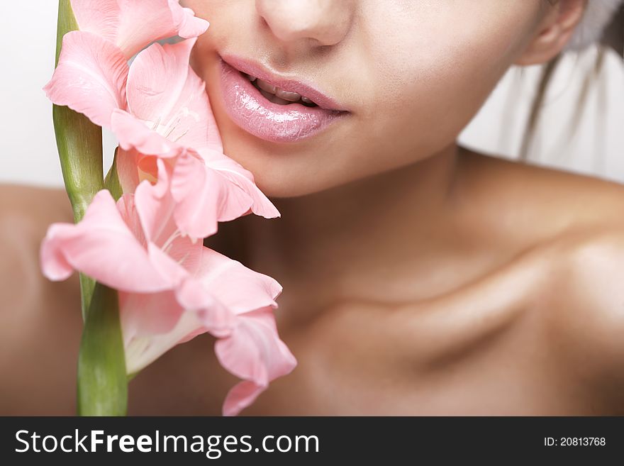 Beautiful women with flower and cosmetic cream