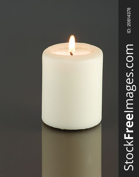 Isolated candle in the dark background. Isolated candle in the dark background
