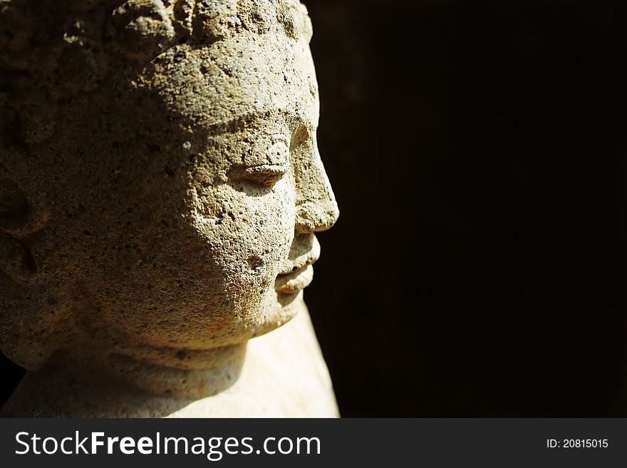 Side profile of a stone buddha