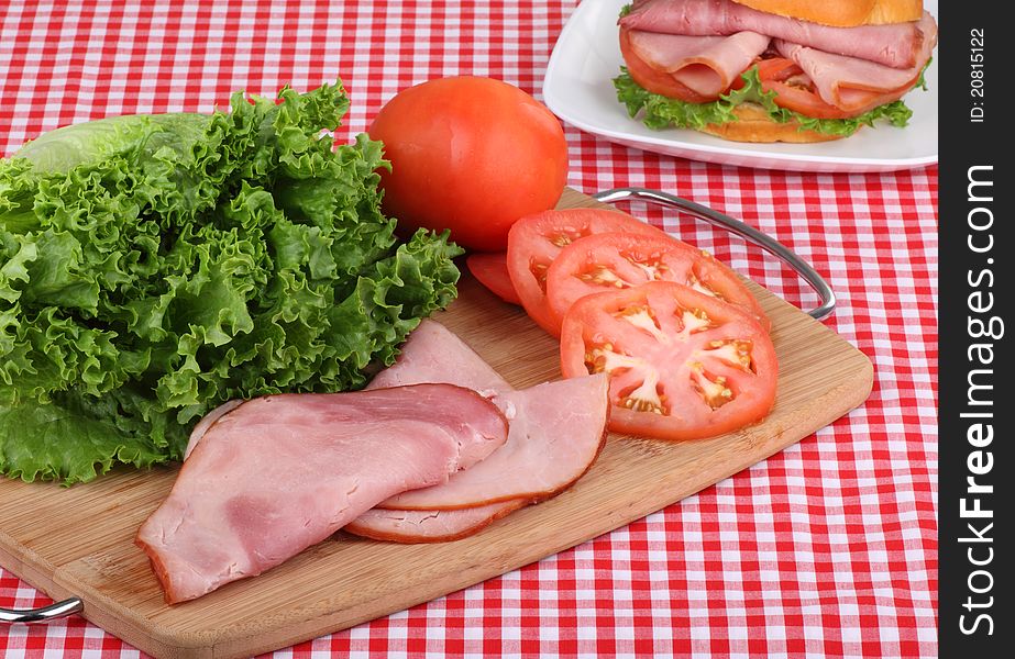 Ham, tomato, and lettuce on a tray for making a ham sandwich. Ham, tomato, and lettuce on a tray for making a ham sandwich