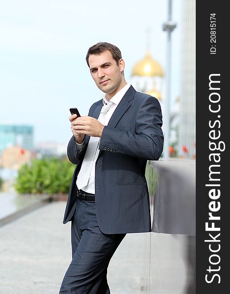 Young man with mobile phone outdoors. Young man with mobile phone outdoors