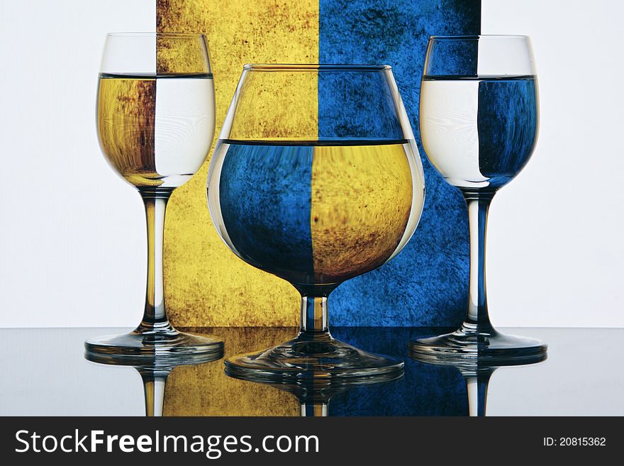 Still life - Glasses on colorful yellow and blue background. Still life - Glasses on colorful yellow and blue background