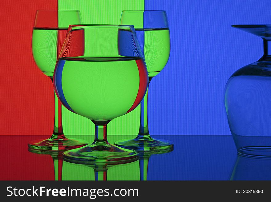 Abstraction - RGB (red, green, blue). Glasses on colorful background.