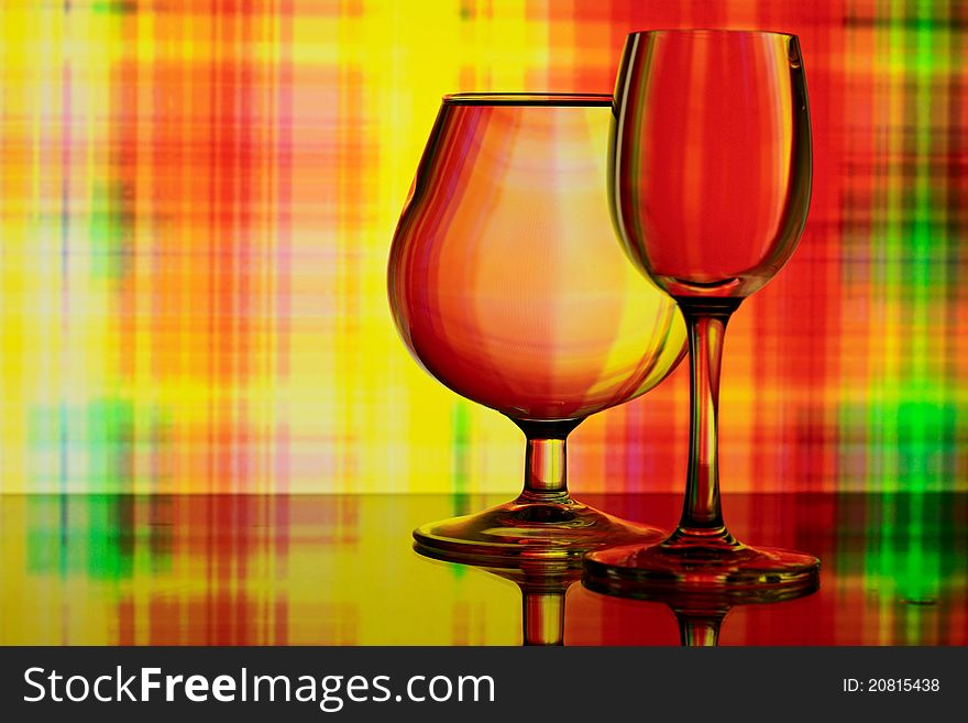 Two glasses on colorful abstract background