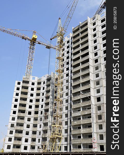 Construction of a residential community. Construction sites with cranes. Concrete structures. Construction of a residential community. Construction sites with cranes. Concrete structures.