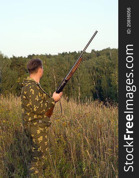 Outdoor shoot of man in camouflage with a shotgun. Outdoor shoot of man in camouflage with a shotgun.