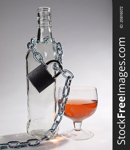 Color photo of bottles of whiskey and metal chain. Color photo of bottles of whiskey and metal chain