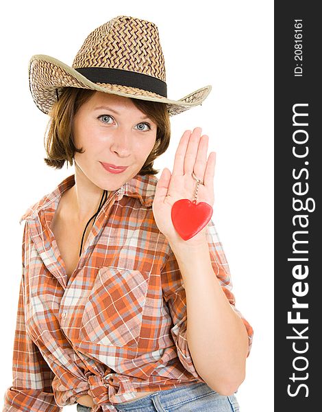 Beautiful cowboy woman holding a red heart in her hand on a white background.