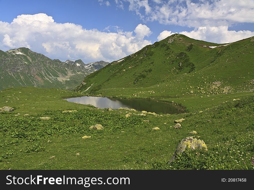 Small Mountain Lake Under Cloudy Sky