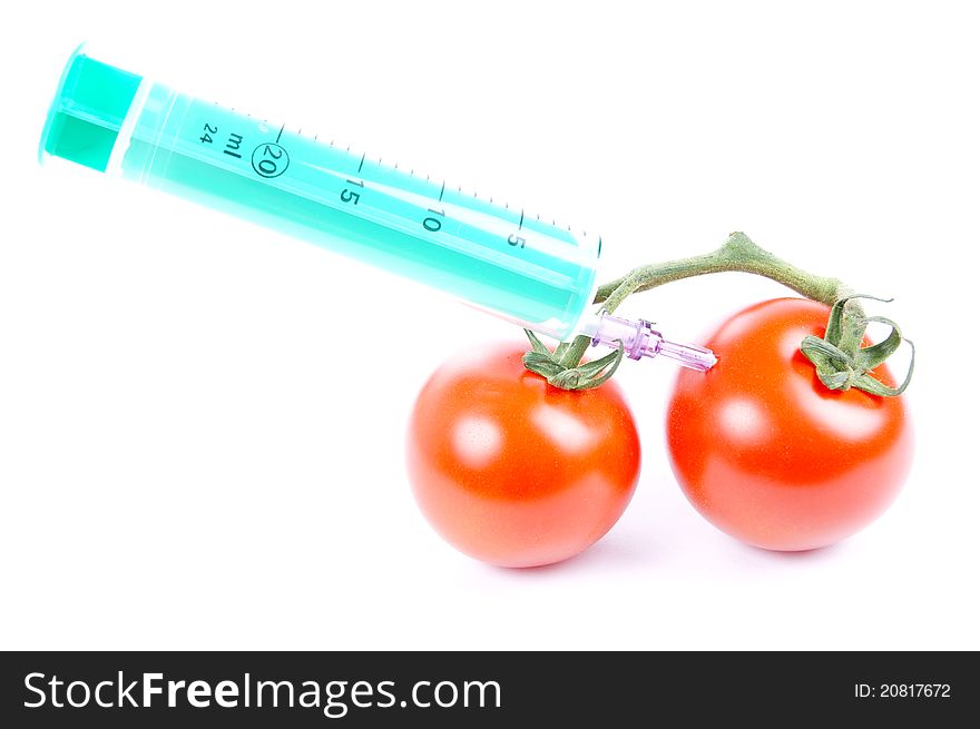 Tomatoes and syringe isolated of a white background. Tomatoes and syringe isolated of a white background