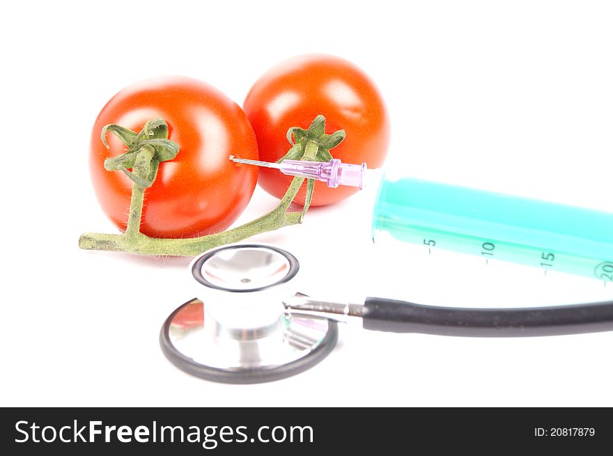 Tomatoes and syringe isolated of a white background. Tomatoes and syringe isolated of a white background